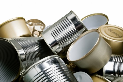 Operatives handling waste bins with protective gear in a commercial setting